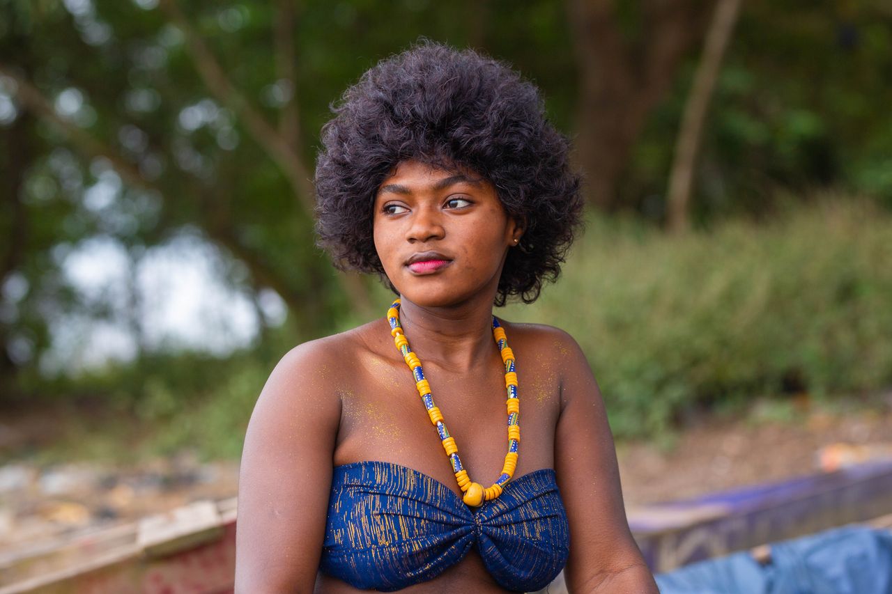 Elegant portrait of a woman in traditional attire with beaded necklace in Accra, Ghana.